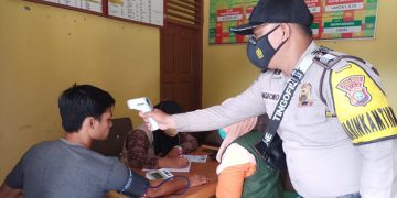 Bhabinkamtibmas Polsek Kerumutan Terus Kawal Vaksinasi di Desa Binaannya